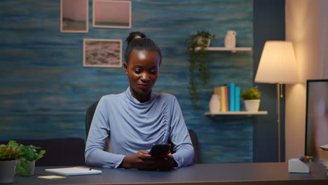 African-lady-taking-break-typing-on-smartphone