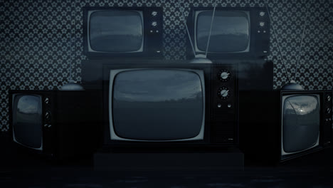 An-exhibition-of-old-fashioned-retro-color-tv-sets-with-antennas.-Electronic-devices-stack-in-front-of-vintage-wallpaper.-Obsolete-television-is-displaying-a-green-screen.