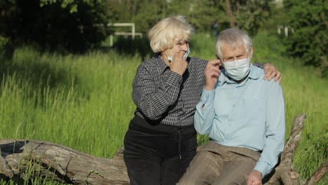 Senior-couple-family-takes-off-medical-masks-after-coronavirus-quarantine-end