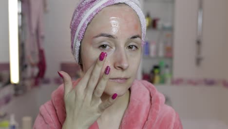 Woman-applying-mask-moisturizing-skin-cream.-Skincare-spa.-Facial-mask