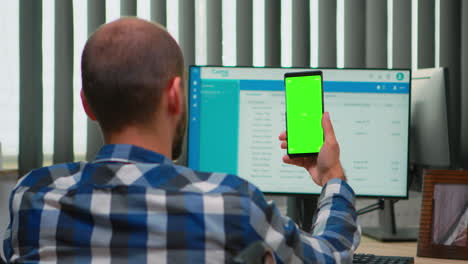 Businessman-in-wheelchair-using-smartphone-with-green-screen