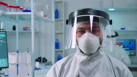 Portrait-of-tired-scientist-man-in-ppe-suit-looking-at-camera