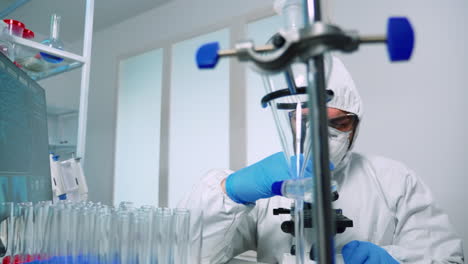 Researcher-in-ppe-suit-conducting-DNA-experiments