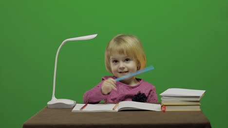 Girl-drawing-at-the-table.-Education-process-in-classroom.-Chroma-Key