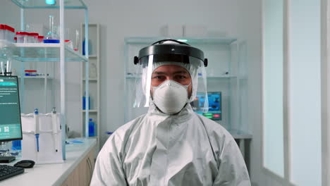 Scientist-in-ppe-suit-looking-exhausted-at-camera-in-lab