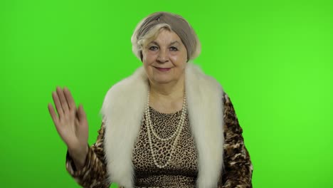 Elderly-stylish-grandmother.-Caucasian-woman-waves-her-hands,-greets.-Chroma-key