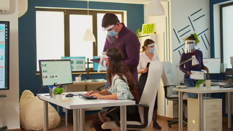 Coworkers-with-protection-face-masks-working-together