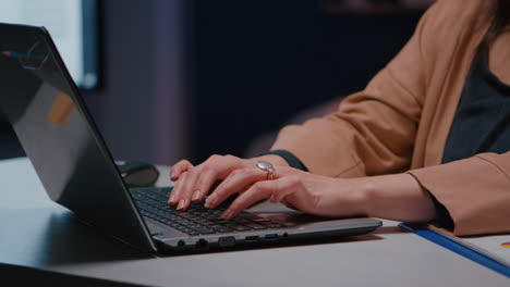 Close-up-of-businesswoman-hands-on-keyboard-sitting-at-desk-in-startup-company-office