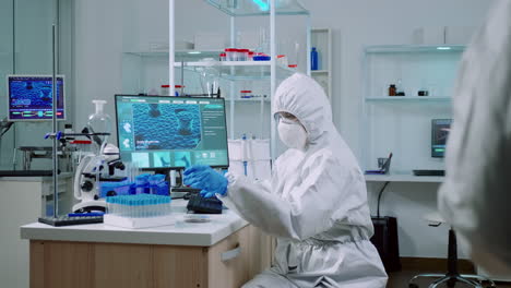 Doctor-with-protection-suit-working-with-blood-samples