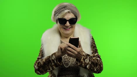 Elderly-stylish-trendy-caucasian-grandmother-woman-using-smartphone.-Chroma-key