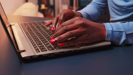 Close-up-of-black-woman-typing-on-keyboard-of-laptop