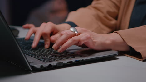 Close-up-of-businesswoman-hands-sitting-at-desk-table-in-business-company