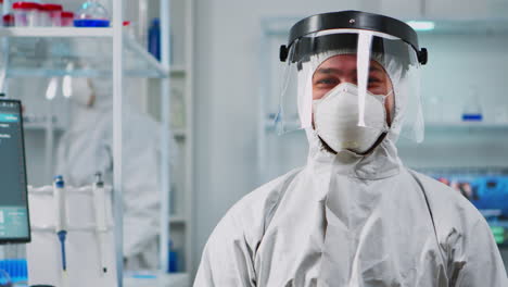 Scientist-man-wearing-coverall-smiling-at-camera