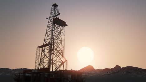 A-big-drill-rig-during-sunrise-on-the-oil-field.-A-metal-construction-used-in-the-petrochemical-industry.-Equipped-with-large-drills-the-structure-can-drill-oil-wells-or-natural-gas-extraction-wells.