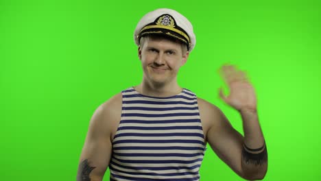 Young-sailor-man-waving-hands.-Seaman-guy-in-sailor's-vest.-Chroma-key