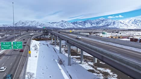 Aerial-next-to-flyover-at-Salt-Lake-City-Spaghetti-Bowl,-snow-covered-landscape