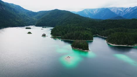 Aerial-view-of-beautiful-Lake-Eibsee-at-the-base-of-the-mountain-Zugspitze,-Scenic-lake-islands-in-the-mountain,-Germany