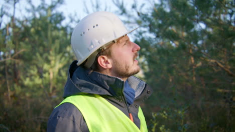 Adult-male-contractor-in-countryside-location-checking-surroundings