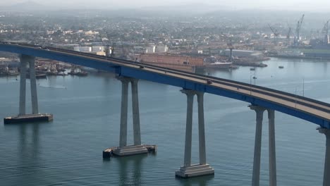 Cars-on-the-San-Diego-Coronado-Bridge---sweeping,-dynamic-aerial-reveal