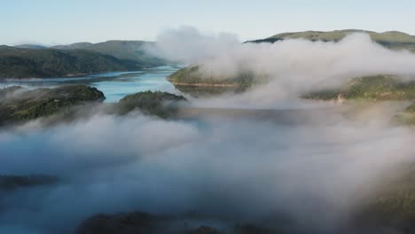 Thin-morning-fog-hangs-above-the-valley-and-the-lake-dam