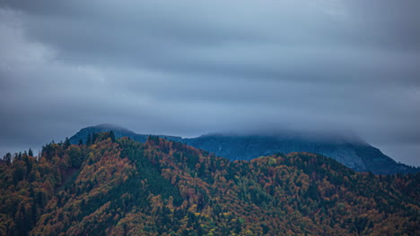 Low-hanging-fog-and-rain-clouds-pass-over-the-mountains-in-a-time-lapse-shot