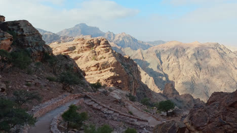Toma-Panorámica-De-Un-Cañón-Rocoso-Con-Una-Escalera-De-Piedra-En-Petra-Jordania.