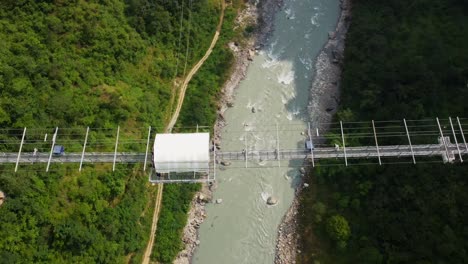 Aerial-top-down-shot-of-bungee-Jumping-on-bridge-over-river-in-Pokhara,-Nepal