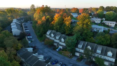 Suburban-neighborhood-at-dawn,-townhouses-and-autumn-foliage