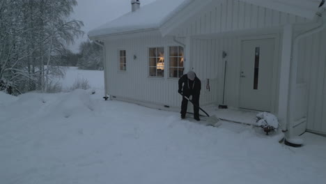woman-shoveling-snow-in-front-of-her-house