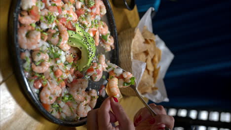 Slow-motion-of-a-woman-eating-a-shrimp-ceviche-and-a-fly-landing-on-the-food