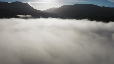 Dense-morning-clouds-backlit-by-the-morning-sun-hangs-above-the-valley
