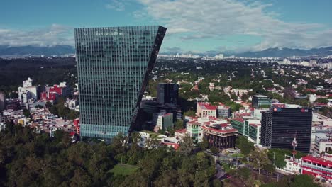 Panoramic-lateral-track-of-Virreyes-tower-in-a-sunny-fall-day-in-Mexico-City
