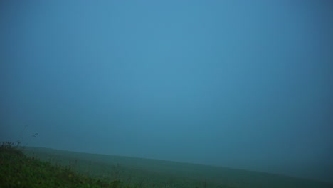 Low-hanging-fog-and-rain-clouds-pass-over-the-landscape
