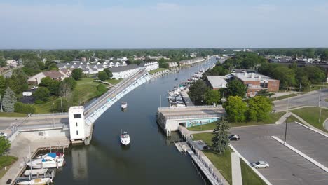Boats-passing-underneath-Erie-Street-Bridge,-Port-Huron,-Michigan,-USA
