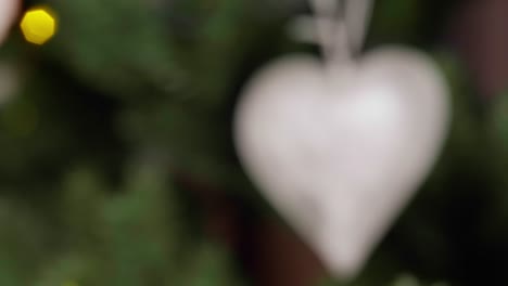 Christmas-tree-decoration-shaped-as-frozen-heart,-closeup-rack-focus