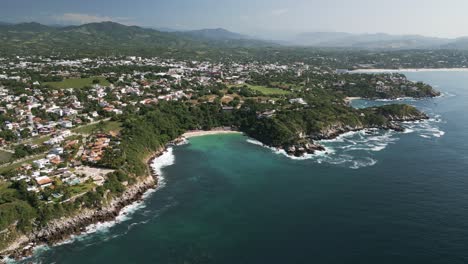 Aerial-hing-angle-of-Puerto-Escondido-Oaxaca-coastline-travel-holiday-surf-destination-in-Mexico