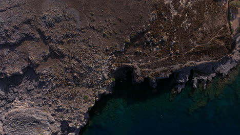 Descending-aerial-shot-over-rough-Rhodes-coastline