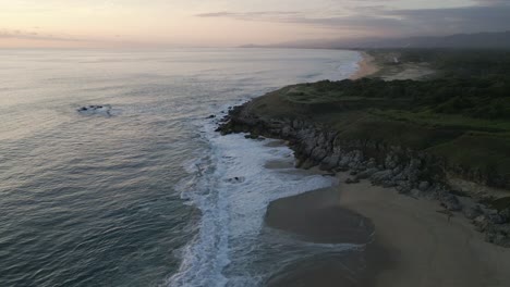 Aerial-sunset-at-lonely-wild-tropical-ocean-beach-with-seascape