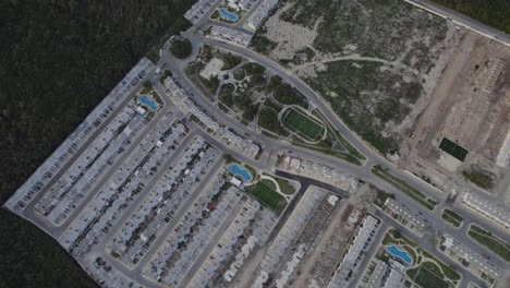 Aerial-drop-down-view-luxury-resort-town-villas-in-Riviera-Maya,-Cancun-Mexico
