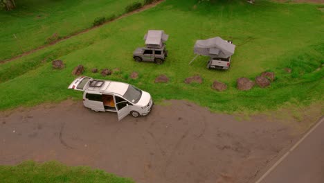 aerial-drone-shot-of-camping-cars-on-a-meadow