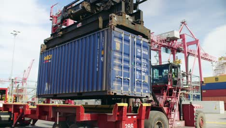 Crane-truck-lifting-heavy-container-in-Port-of-Montreal-shipping-terminal