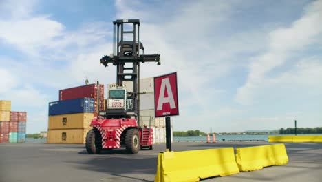 Crane-truck-arriving-at-Port-of-Montreal-zone-A-collecting-heavy-stacked-shipping-containers