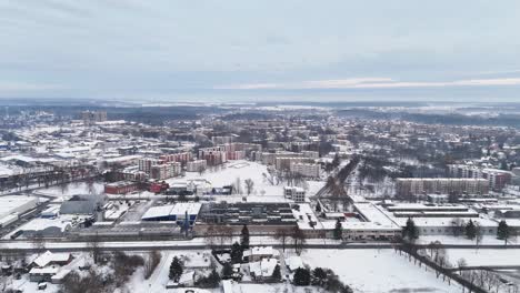 Drone-push-in-to-block-buildings-covered-in-snow,-Silute-Lithuania