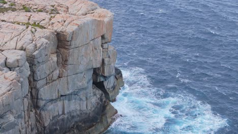 Wild-rough-waves-crash-against-rocky-cliff
