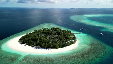 Tropical-Island-Paradise---Malahini-Kuda-Bandos,-Maldives:-Aerial-drone-anticlockwise-rotate-from-far
