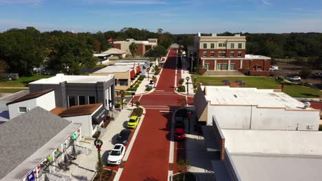 Drone-trucking-pan-above-historic-downtown-Clermont-at-midday-with-empty-sidewalks