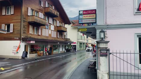 Interlaken-Switzerland-Immersive-Travel-Tourism-Mountainside-Valley-Resort-City,-Europe,-Walking,-Rainy-Day,-4K-|-Looking-Around,-Shaky,-Water,-River,-Lake,-Restaurant,-Tourist,-Boy,-Asian,-Luggage