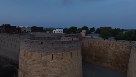 Aerial-of-Umerkot-Fort-landmark-in-Sindh,-Pakistan-after-sunset