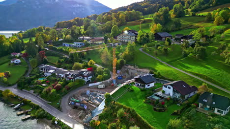 Aerial-view-around-a-construction-site-on-the-coast-of-lake-Attersee,-fall-in-Austria