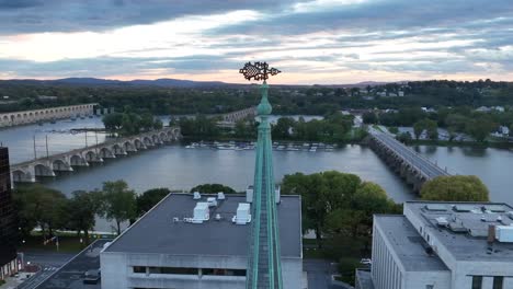 Spire-with-Susquehanna-River-and-bridges-in-the-background-during-sunset-in-Harrisburg,-Pennsylvania